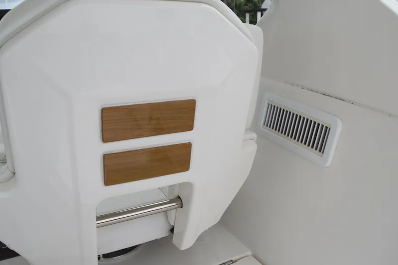  Yacht Photos Pics 2022 Pursuit OS 355 Offshore boat interior with wooden accents and vent detail.