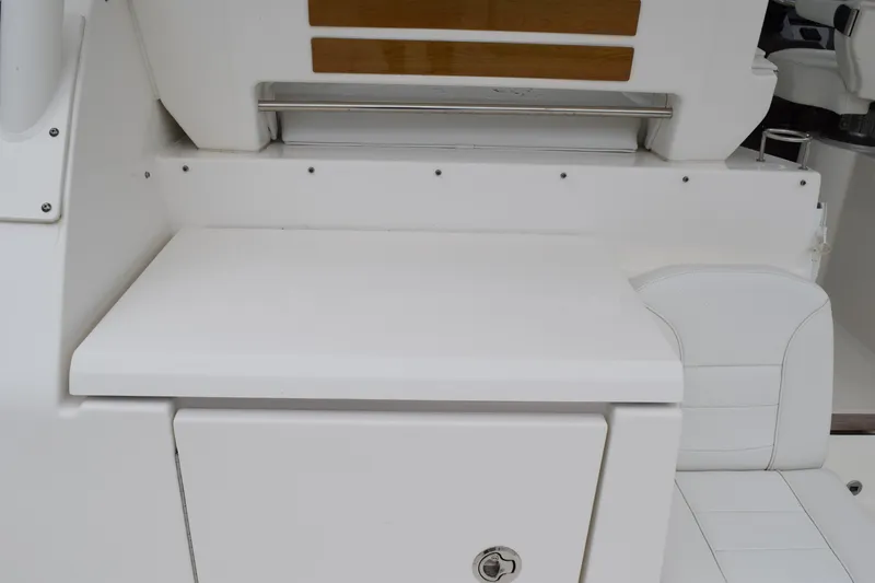  Yacht Photos Pics 2022 Pursuit OS 355 Offshore boat interior with white seating and storage area.