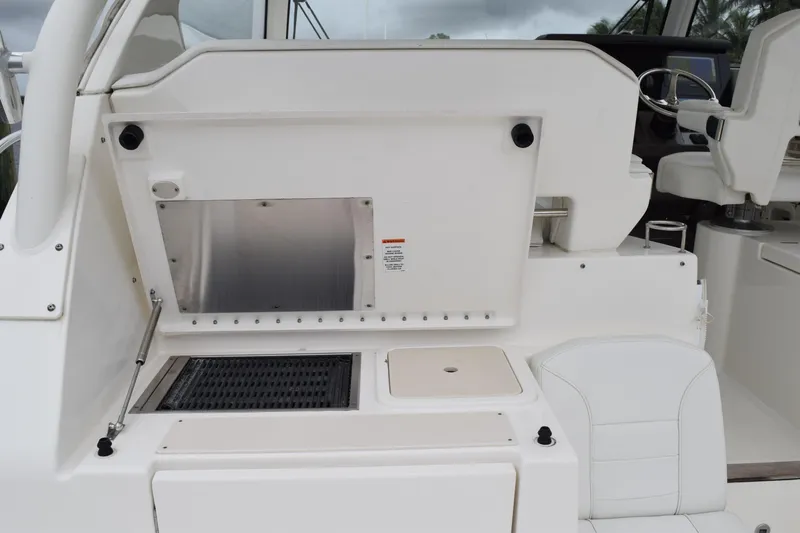  Yacht Photos Pics 2022 Pursuit OS 355 Offshore boat interior with seating and control panel.