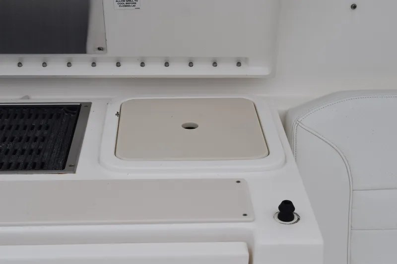  Yacht Photos Pics 2022 Pursuit OS 355 Offshore boat interior with grill and seating area.