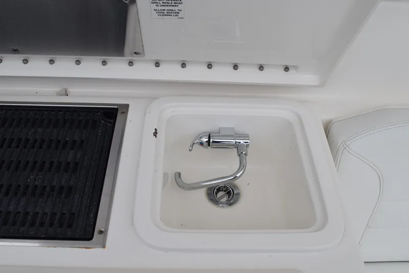  Yacht Photos Pics 2022 Pursuit OS 355 Offshore boat sink and grill area.