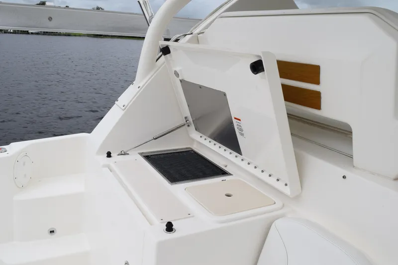  Yacht Photos Pics 2022 Pursuit OS 355 Offshore boat with open storage compartment and sleek design.