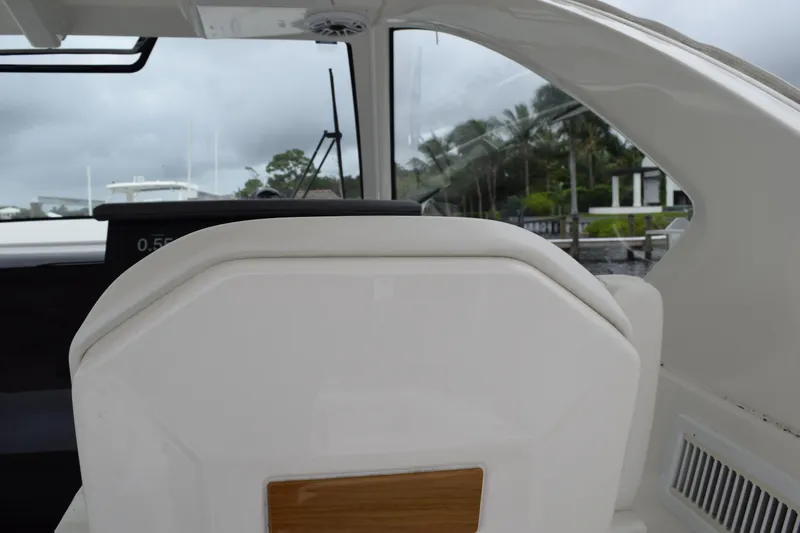  Yacht Photos Pics 2022 Pursuit OS 355 Offshore boat interior with white seating and window view.