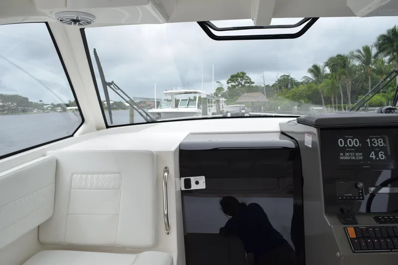  Yacht Photos Pics Interior view of 2022 Pursuit OS 355 Offshore boat with navigation display and seating.