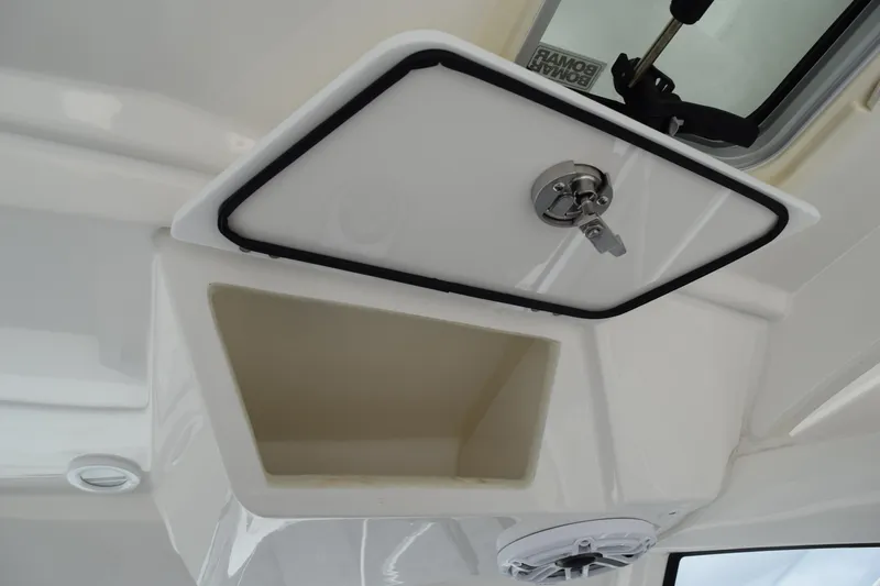  Yacht Photos Pics 2022 Pursuit OS 355 Offshore storage compartment with secure latch and speaker.