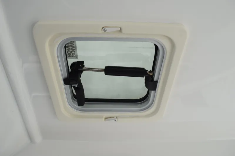  Yacht Photos Pics 2022 Pursuit OS 355 Offshore boat window with secure latch mechanism.