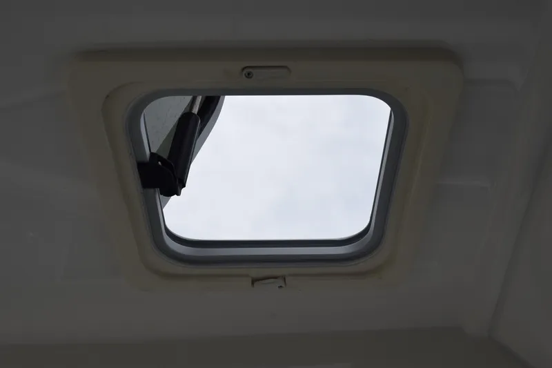  Yacht Photos Pics Open hatch on 2022 Pursuit OS 355 Offshore boat, showcasing sky view.