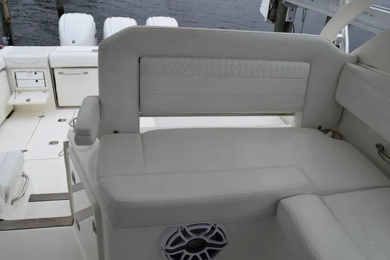  Yacht Photos Pics 2022 Pursuit OS 355 Offshore boat interior with white seating and storage compartments.