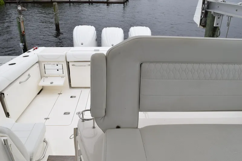  Yacht Photos Pics 2022 Pursuit OS 355 Offshore boat interior with seating and storage compartments.