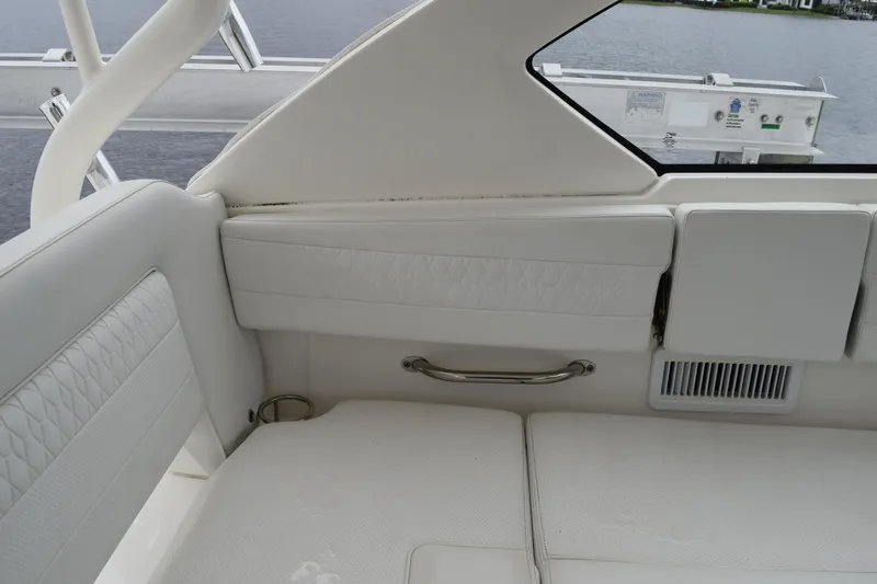 Yacht Photos Pics 2022 Pursuit OS 355 Offshore boat interior with white seating and stainless steel handle.