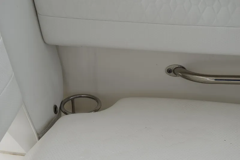  Yacht Photos Pics Interior detail of 2022 Pursuit OS 355 Offshore boat, featuring white upholstery and metal handle.