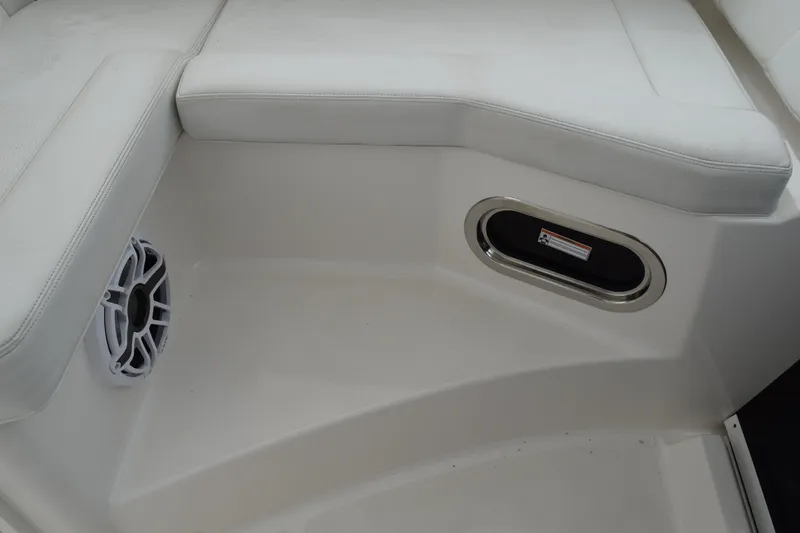  Yacht Photos Pics 2022 Pursuit OS 355 Offshore boat interior with cushioned seating and speaker.