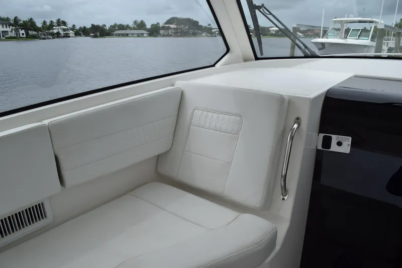  Yacht Photos Pics Interior of 2022 Pursuit OS 355 Offshore boat with white seating and lake view.