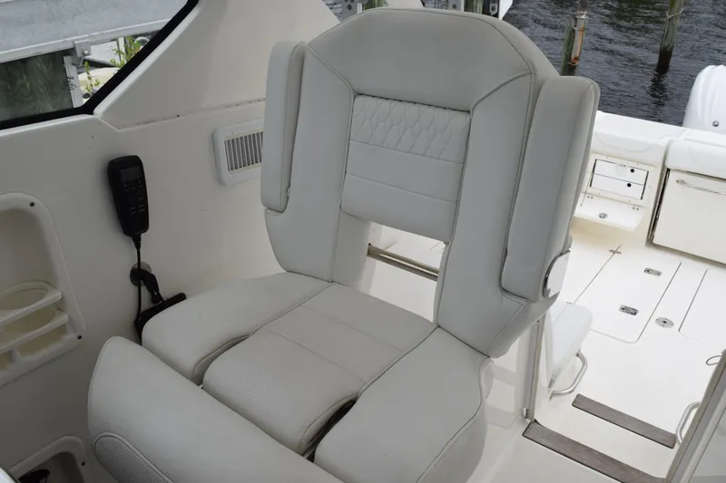  Yacht Photos Pics 2022 Pursuit OS 355 Offshore boat interior with luxurious white captain's chair.