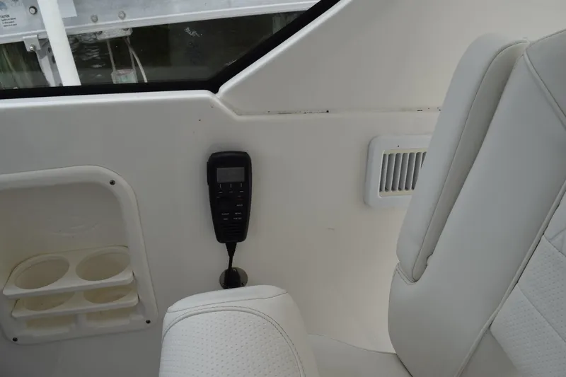  Yacht Photos Pics Interior of 2022 Pursuit OS 355 Offshore boat with white seating and control panel.