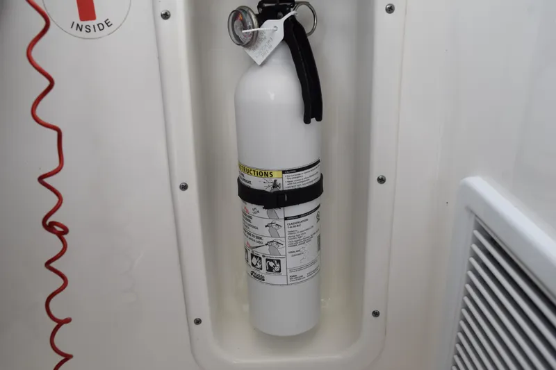  Yacht Photos Pics Fire extinguisher mounted on 2022 Pursuit OS 355 Offshore boat interior.