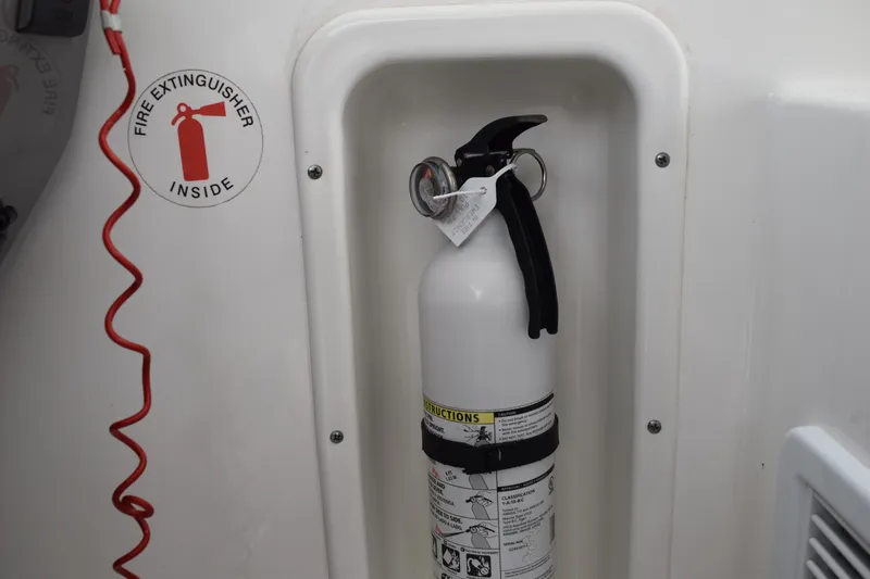  Yacht Photos Pics Fire extinguisher in 2022 Pursuit OS 355 Offshore boat compartment.