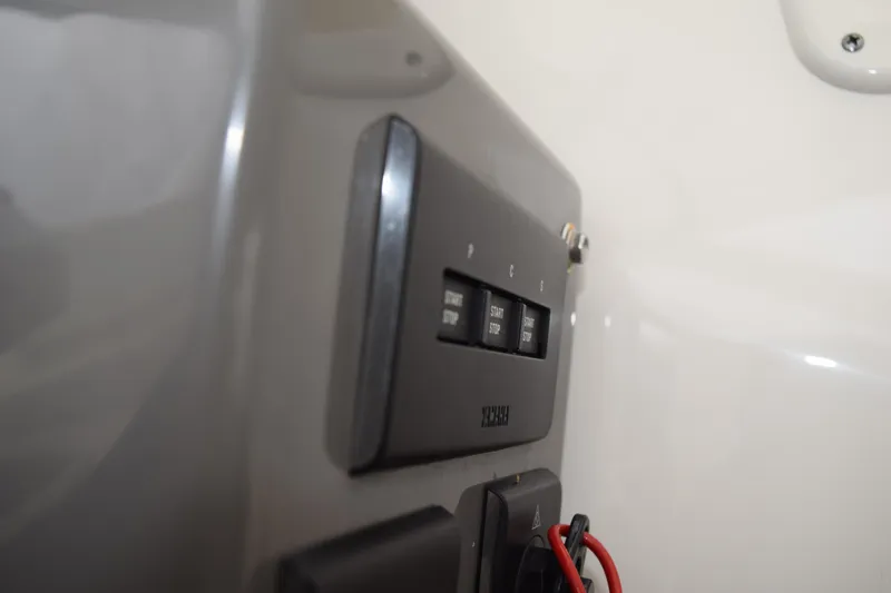  Yacht Photos Pics Control panel on a 2022 Pursuit OS 355 Offshore boat, featuring start/stop buttons.