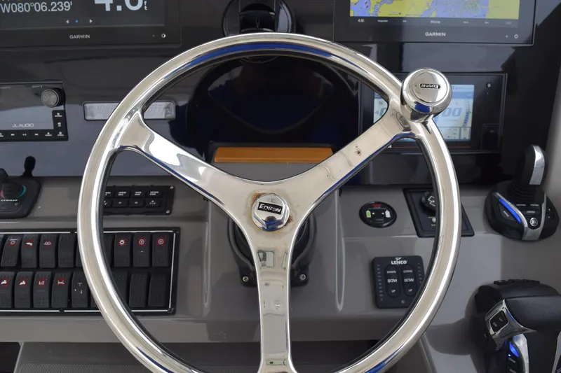  Yacht Photos Pics Steering wheel and controls of 2022 Pursuit OS 355 Offshore boat cockpit.