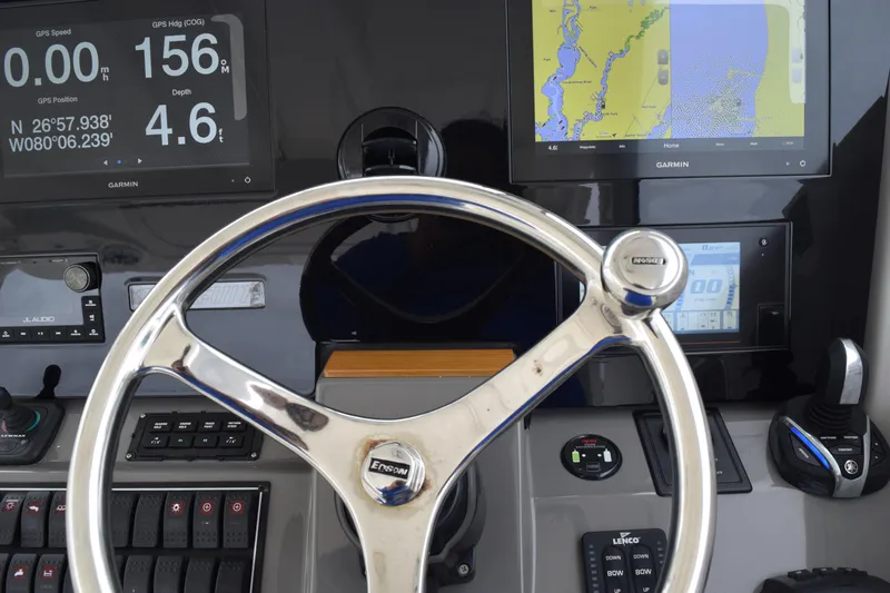  Yacht Photos Pics Steering wheel and dashboard of 2022 Pursuit OS 355 Offshore boat with navigation displays.