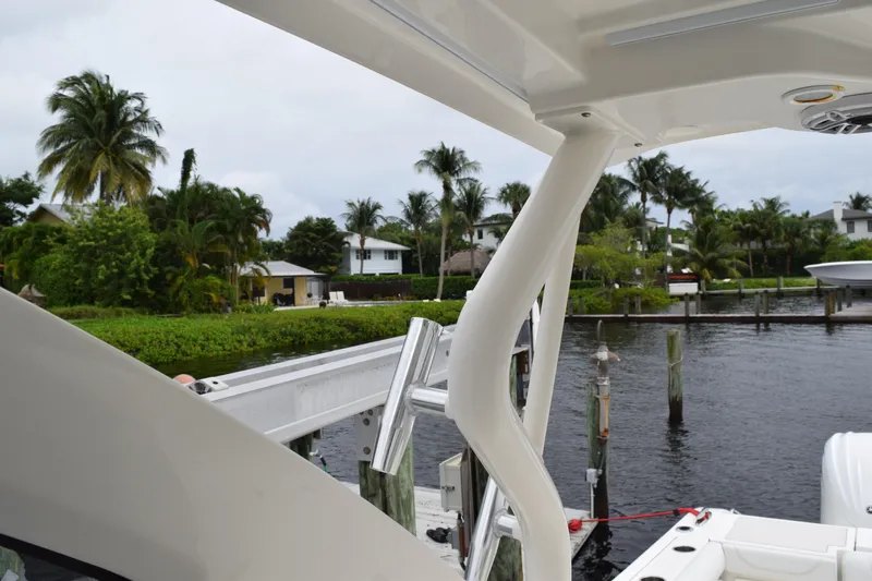  Yacht Photos Pics 2022 Pursuit OS 355 Offshore boat docked near tropical waterfront homes.