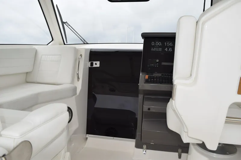  Yacht Photos Pics Interior of 2022 Pursuit OS 355 Offshore boat with white seating and navigation console.