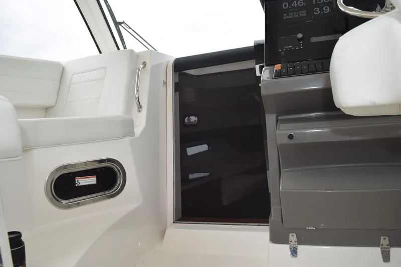  Yacht Photos Pics 2022 Pursuit OS 355 Offshore boat interior with white seating and control panel.