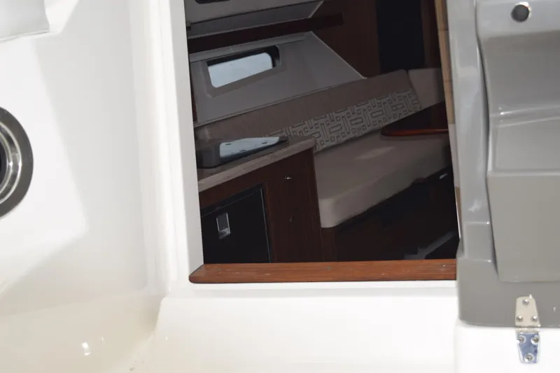  Yacht Photos Pics Interior view of 2022 Pursuit OS 355 Offshore boat cabin with seating and cabinetry.