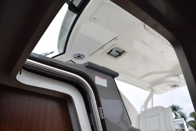  Yacht Photos Pics 2022 Pursuit OS 355 Offshore boat interior view with open hatch and seating.