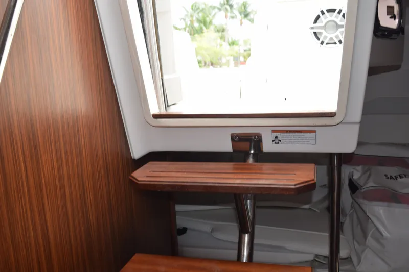  Yacht Photos Pics Interior view of 2022 Pursuit OS 355 Offshore boat with wooden steps and window.