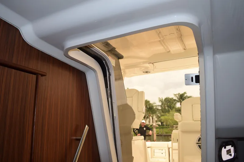  Yacht Photos Pics Interior view of 2022 Pursuit OS 355 Offshore boat, showcasing cabin entrance and seating area.