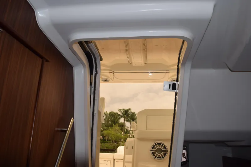  Yacht Photos Pics Interior view of 2022 Pursuit OS 355 Offshore boat, showcasing door and seating area.