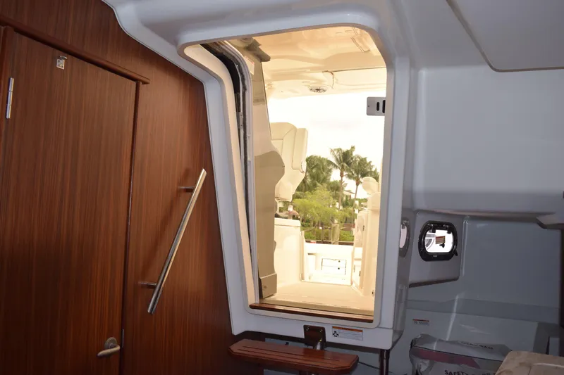  Yacht Photos Pics Interior view of 2022 Pursuit OS 355 Offshore boat, showing cabin door and seating area.