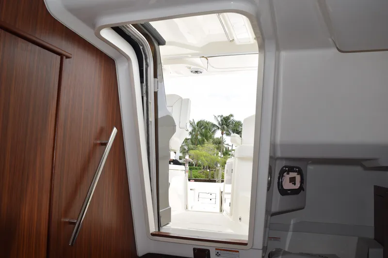  Yacht Photos Pics Interior view of 2022 Pursuit OS 355 Offshore boat, showing cabin entrance and outdoor seating.