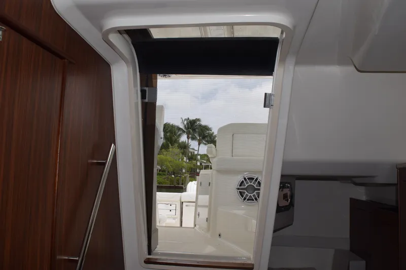  Yacht Photos Pics Interior view of 2022 Pursuit OS 355 Offshore boat, showing cabin entrance and outdoor seating.