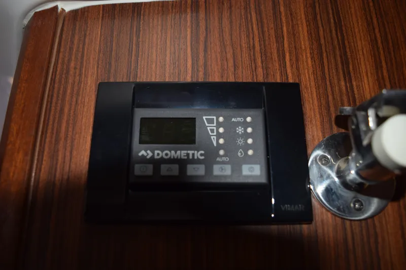  Yacht Photos Pics Dometic control panel on 2022 Pursuit OS 355 Offshore boat, mounted on wood panel.