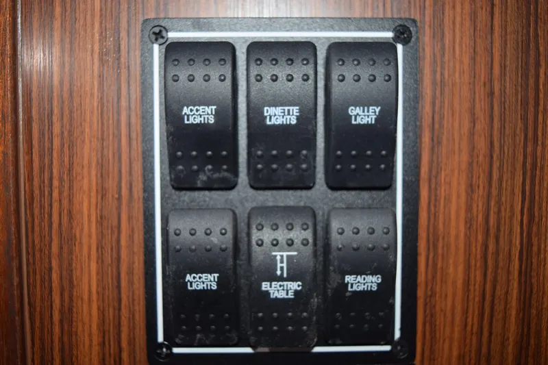  Yacht Photos Pics Switch panel on 2022 Pursuit OS 355 Offshore boat, featuring various light controls.