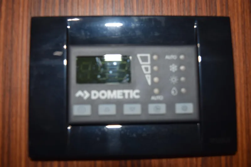  Yacht Photos Pics Dometic control panel on 2022 Pursuit OS 355 Offshore boat, mounted on wooden surface.