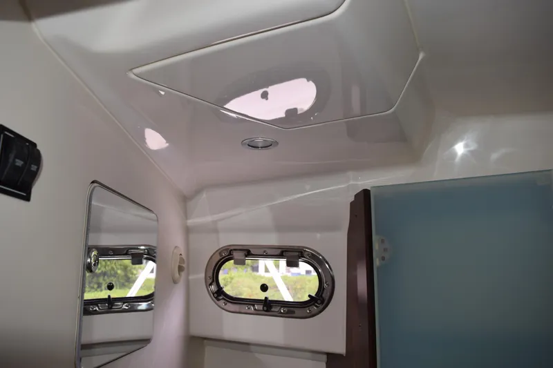  Yacht Photos Pics Interior of 2022 Pursuit OS 355 Offshore boat, featuring a window and mirror.