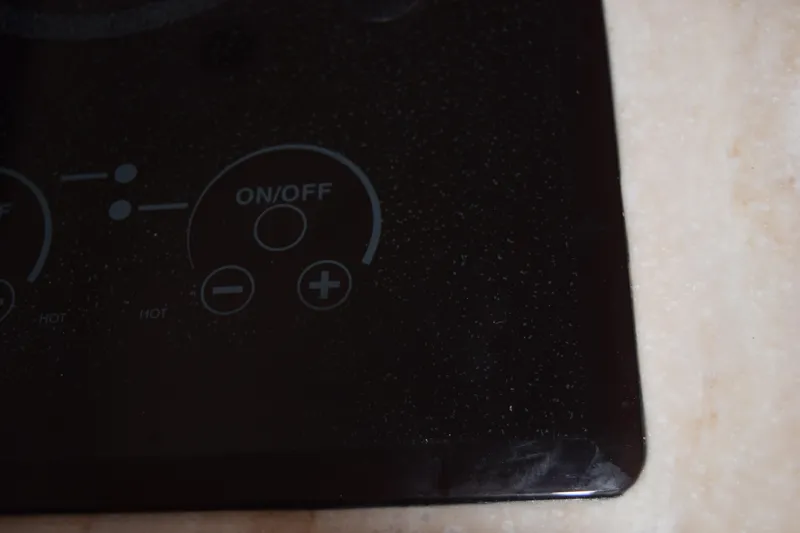  Yacht Photos Pics Control panel of 2022 Pursuit OS 355 Offshore boat, featuring on/off and adjustment buttons.