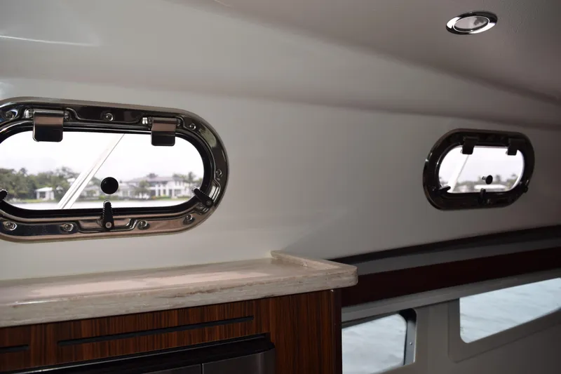  Yacht Photos Pics Interior view of 2022 Pursuit OS 355 Offshore yacht with porthole windows.