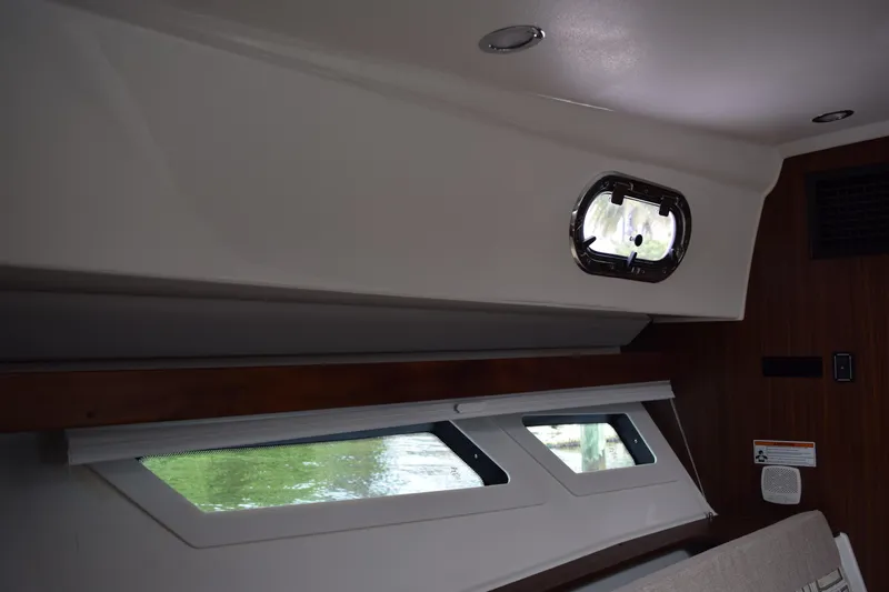  Yacht Photos Pics Interior view of 2022 Pursuit OS 355 Offshore boat cabin with windows and modern design.