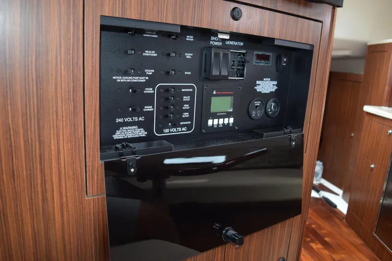  Yacht Photos Pics Electrical control panel inside 2022 Pursuit OS 355 Offshore boat cabin.