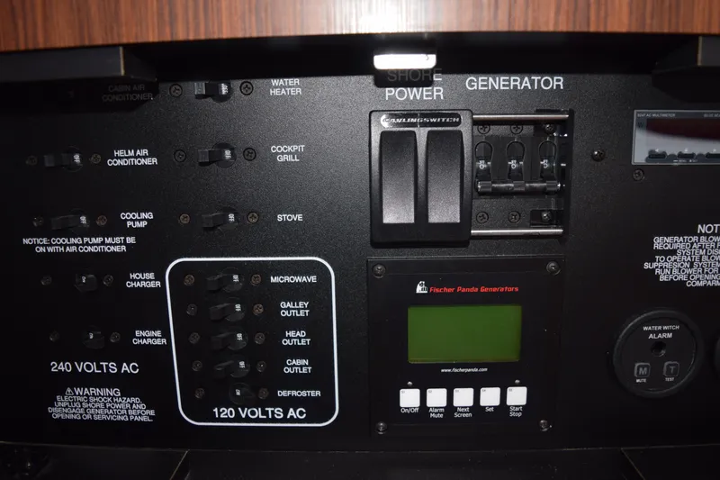  Yacht Photos Pics Control panel of a 2022 Pursuit OS 355 Offshore boat with generator and power switches.
