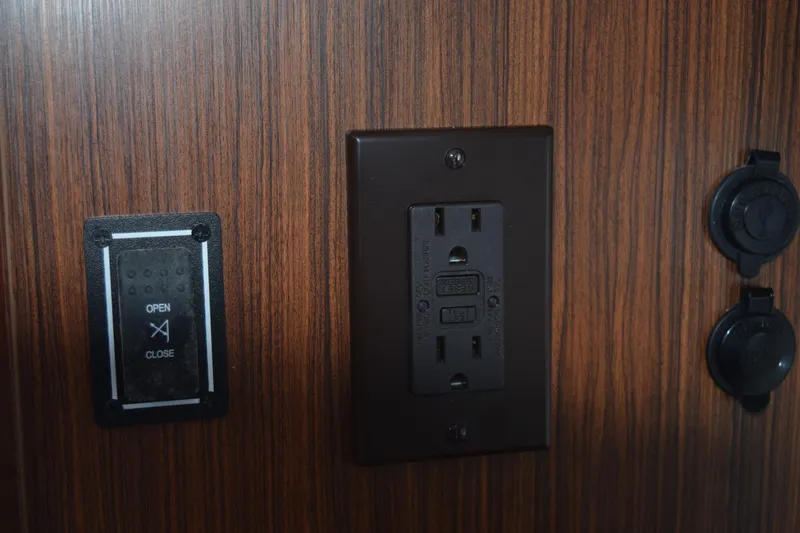  Yacht Photos Pics Control panel and outlet on 2022 Pursuit OS 355 Offshore boat interior.