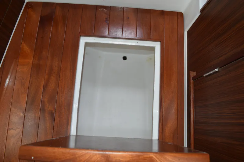  Yacht Photos Pics Interior of 2022 Pursuit OS 355 Offshore boat with wooden paneling.