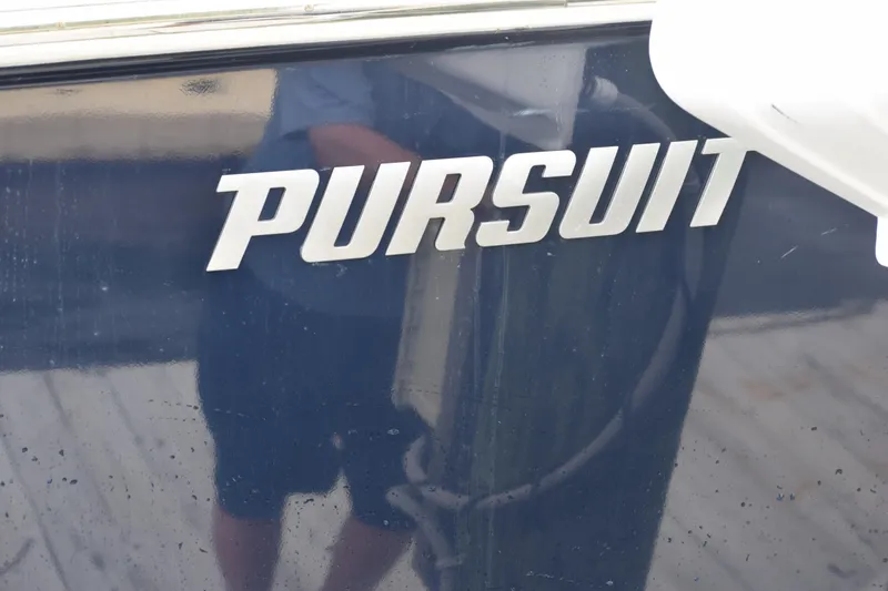  Yacht Photos Pics 2022 Pursuit OS 355 Offshore boat logo on dark surface.
