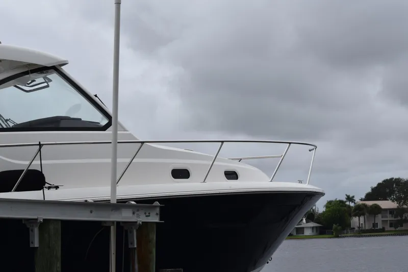  Yacht Photos Pics 2022 Pursuit OS 355 Offshore boat docked under cloudy skies.