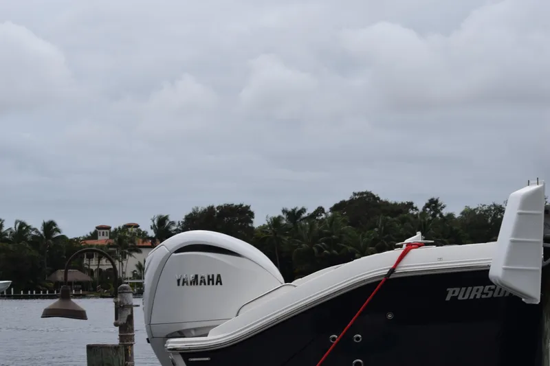  Yacht Photos Pics 2022 Pursuit OS 355 Offshore boat with Yamaha engine docked by waterfront homes.