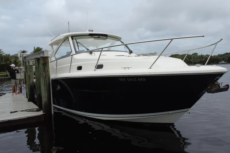  Yacht Photos Pics 2022 Pursuit OS 355 Offshore boat docked on a cloudy day.